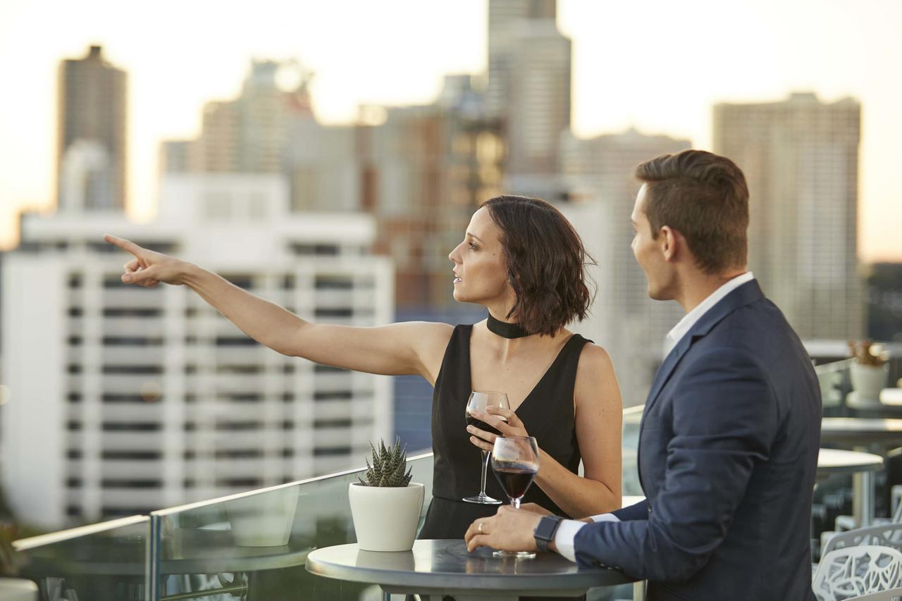 The Point Brisbane Hotel Экстерьер фото A couple at a rooftop party