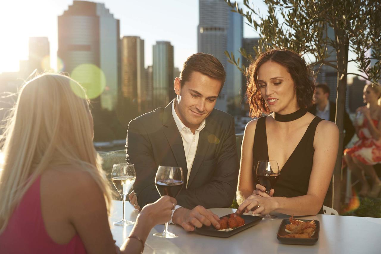 The Point Brisbane Hotel Экстерьер фото A couple dining at a restaurant